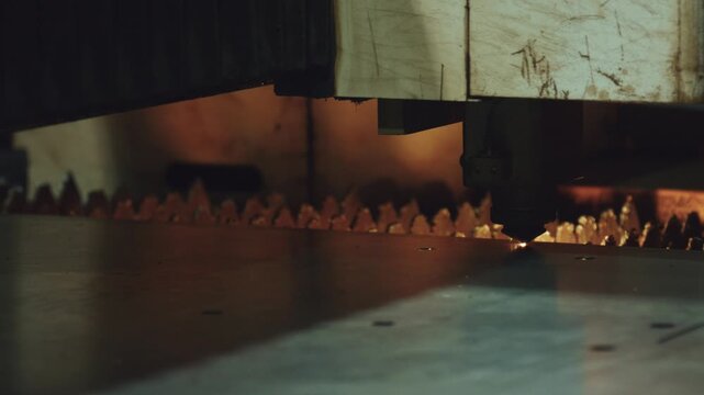 Industrial cnc laser cutting machine meticulously carving through a steel sheet, generating a cascade of bright sparks and smoke in a modern metalworking factory, showcasing precision engineering