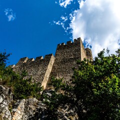 Stone castle walls against a bright sky