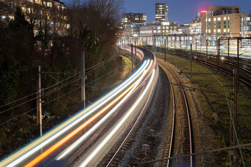 Copenhagen, Denmark - Streaks of Light as a High-Speed Train Navigates City Tracks at Twilight