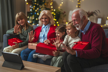 Grandparents and grandchildren celebrating christmas with virtual video call