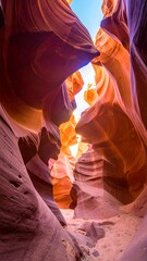 Sunlight streams through a narrow sandstone canyon