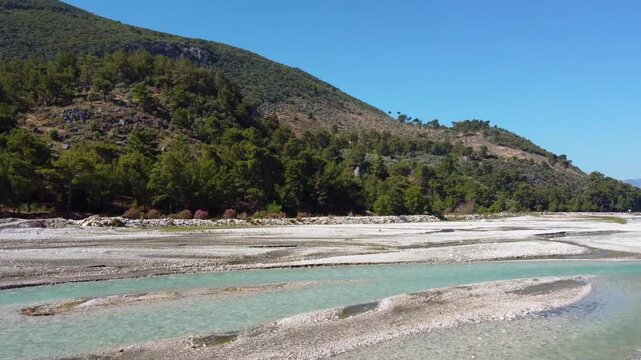 Footage showcasing the natural beauty of Saklıkent National Park in Turkey, featuring the vibrant turquoise waters of the Esen &Ccedil;ayı Xanthos River flowing through the dramatic canyon landscape with lus