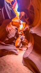 Sunlight streams through a sandstone canyon