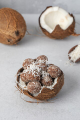 Homemade vegan healthy candies with sugar-free coconut chips, made from dried fruits and nuts 