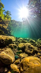Sunlight streams through clear, shallow water over rocks