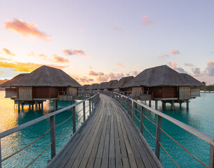 Overwater bungalows Bora Bora turquoise water sunset