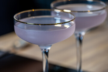 Elegant cocktails in crystal glasses, showcasing a mysterious aura with dry ice and fog, creating an enchanting atmosphere for a party or visual concept