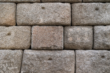Close-up video of an old stone and brick wall, showing rough textured blocks and weathered cement surface, perfect as a rustic architectural background.