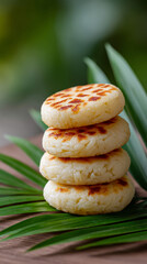 Tower of puto on palm leaf with blurred background - filipino cuisine concept