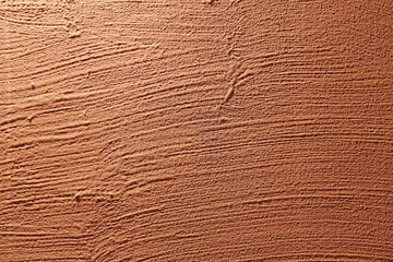 Background of natural beige brown painted stucco in plaster cement texture lined pattern or stone in colors aged Textured illuminated wall fence surface blend of pink peach fuzz red  backdrop.