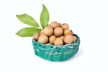 Fresh longan fruit with leaves in green wicker bamboo basket. Isolated on white background with copy space. Tropical Asian fruit. Suitable for editing and used for food and agriculture advertising.