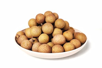 Front view of Fresh longan fruit in white plate. Isolated on white background with copy space. Tropical Asian fruit. Suitable for editing and used for food and agriculture advertising.
