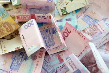 Big amount of different Ukrainian hryvnia money bills. Pile of crumpled ukrainian banknotes