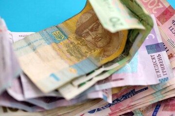 Ukrainian money bills on light blue paper background