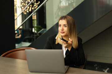 Obraz premium Informal Call. Happy young woman in glasses calling her friend, talking and asking about something, using laptop.