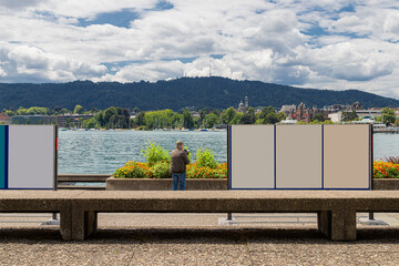 Man Photographing Lake Zurich Waterfront with Blank Billboards for Mock-Up