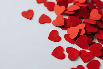 Red heart confetti on white, representing love, romance, and celebration. Great for Valentine's Day, anniversaries, or wedding designs with copy space.