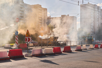 An Urban Construction Site with Smoke and Various Traffic Barriers Observed Nearby