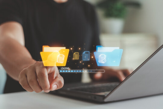 Businessman hand touching with digital document folders and a progress bar, representing file management, data transfer, cloud storage and digital workflow in business or office environments.