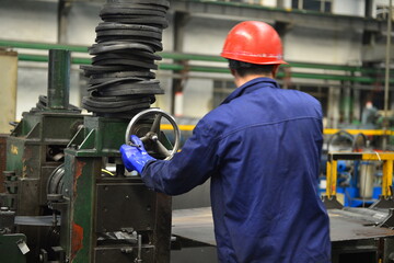 Workers on the production line of the strip steel coil factory are working