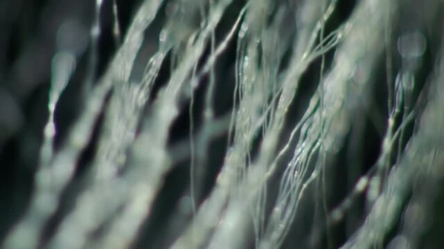 Macro Cinematic Shot of Light Refracting Through Synthetic Fibers with a Dark Background Abstract Motion of Interwoven Threads for Texture or Backgrounds and Creative Visuals in Advertising