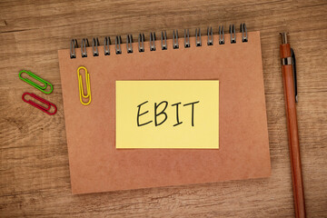 There is sticky note with the word EBIT. It is an abbreviation for Earnings Before Interest and Taxes as eye-catching image.