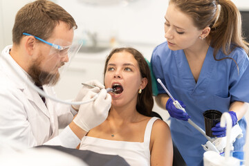Young woman came to professional dental hygiene to remove tooth stone and whitening. Dentist...