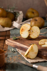 A rustic still life with sliced russet apples sprinkled with cinnamon on a wooden cutting board, evoking a cozy, autumnal mood