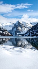 Snowy mountain lake reflecting a vibrant sky