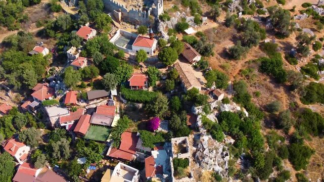 aerial perspective captures the historic Simena Castle also known as Kalek&ouml;y overlooking the turquoise waters of Kekova Island in Antalya, Turkey.