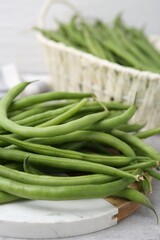 Fresh green bean pods on grey table, closeup