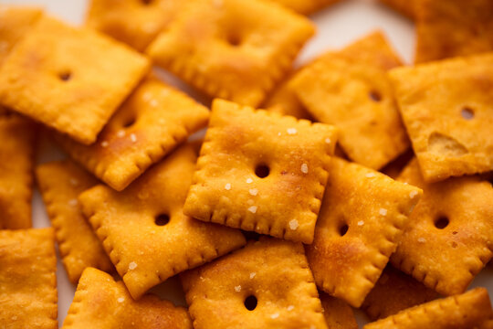 Salted Cheddar Cheese square crackers in a big pile 