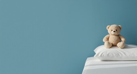 A cute stuffed bear toy sitting on a white pillow in a minimalist bedroom. Childhood concept with copy space on a blue background