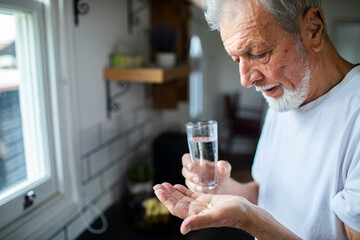Senior man taking medication