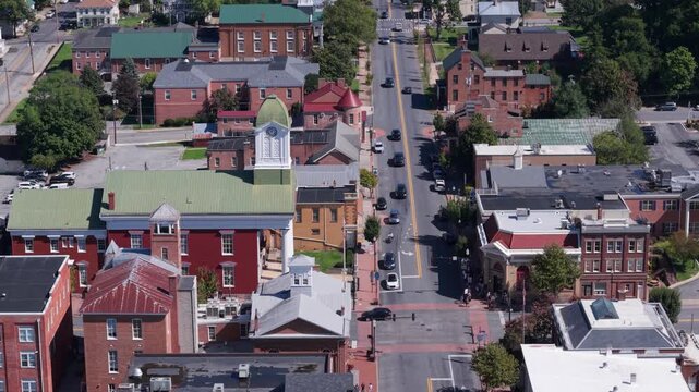 Experience an aerial view of Main Street in Charles Town, West Virginia, showcasing the courthouse and vibrant community on a clear autumn day.