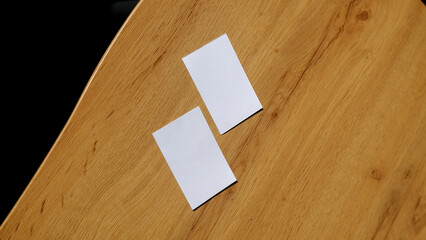 Plain business card paper on the wooden table surface