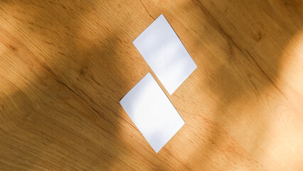 Plain business card paper on the wooden table surface