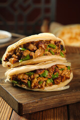 Hearty Breakfast Burrito with Meat and Eggs on Wooden Board - Morning Meal Food Photography