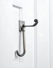 Stylish, ornate coat hook on white door