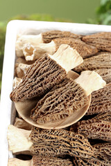 Dried Morel Mushrooms from Yunnan China in White Container Display for Gourmet Cooking