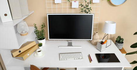 Interior of office with workplace, tablet and computer