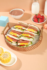 Delicious Breakfast Sandwiches with Eggs and Bacon in Wicker Basket Morning Meal Setup