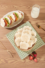 Bear Paw Shaped Buns with Fresh Sandwiches and Milk on Wooden Table - Creative Kids Food Concept