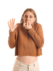 Young woman feeling bad smell on white background