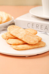 Crispy Rice Cakes Snack on White Plate with Cereal Container Background