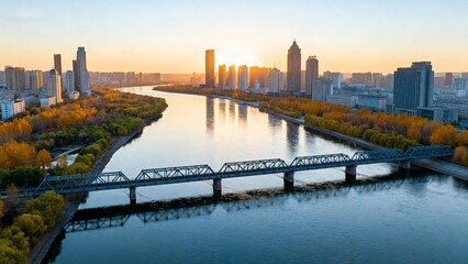Cityscape with river and bridge at sunset