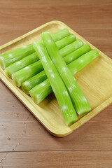 Fresh Green Celery Sticks Cut on Wooden Cutting Board - Healthy Vegetable Preparation