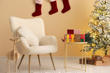 Interior of living room with armchair, glowing Christmas tree and Advent calendar