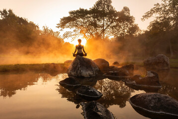 Healthy Yoga woman lifestyle balanced practicing meditate and energy yoga on the bridge in morning and sunset outdoors nature. Healthy life Concept