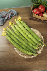 Fresh Silkmelon Cucumbers with Vegetables on Wooden Table